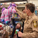 Valdosta Police Chief Leslie Manahan was paired with Skyler Putnam for Shop with a Cop. Manahan helped Putnam pick out a stuffed unicorn as one of her first stops in Walmart. — File photo